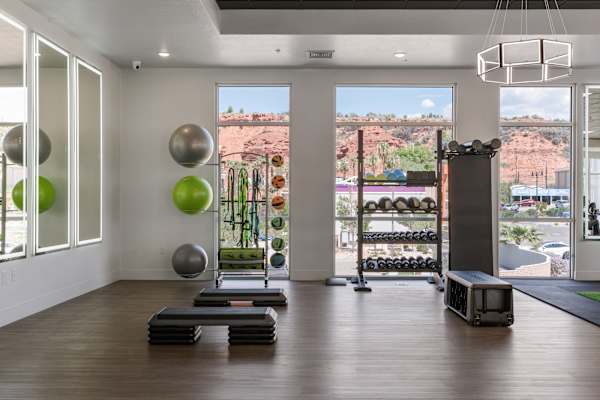 A gym with a view of the outdoors and window at 605 Place Student Housing & Co-Living, St George, UT 84770